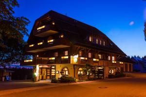 a large building with a gambrel roof at night at Solhof-Schömberg in Loßburg
