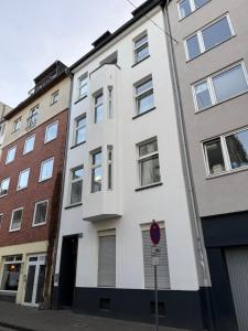 a white building on the side of a street at Royale Apartaments Central City Cologne in Cologne +10 photos
