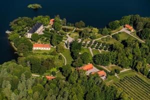an aerial view of a house on a island in the water at The Gardener House - Grönsöö Palace Garden in Grönsöö