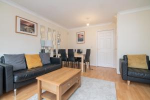 a living room with a couch and a table at Fantastic 4 bed house with 3 bathrooms in pleasant location in Great Barr
