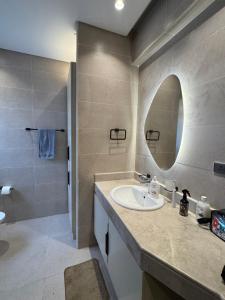 a bathroom with a sink and a mirror at Charming privado in Madinaty +21 photos