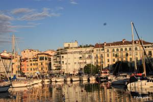 a group of boats docked in a harbor with buildings at San Pietro D'Orio Apartment in Grado