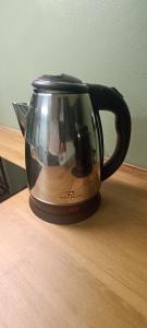 a black coffee pot sitting on a wooden table at Volta B&B Imola in Imola