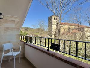 a cat sitting on a balcony looking out of a window at Casa individual - Villa Castillo 7804 in Castillo
