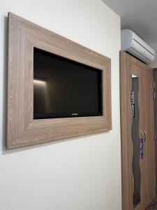 a flat screen tv hanging on a wall at Brit Hotel Montargis in Mormant-sur-Vernisson
