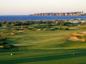 a golf course with the ocean in the background at Palmares Beach House Hotel - Adults Only in Lagos
