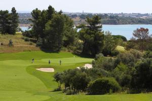 a group of golfers on a lush green course at Palmares Beach House Hotel - Adults Only in Lagos