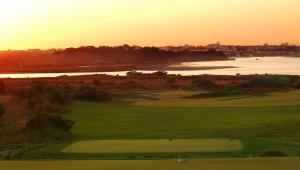 a view of a golf course with the sunset in the background at Palmares Beach House Hotel - Adults Only in Lagos