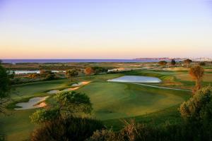 an aerial view of a golf course with two ponds at Palmares Beach House Hotel - Adults Only in Lagos