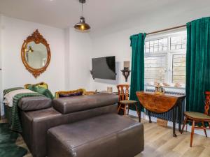 a living room with a couch and a table at Shell Cottage in Bournemouth