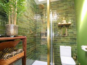a bathroom with a glass shower with a toilet at Shell Cottage in Bournemouth +19 photos