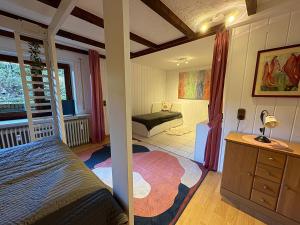 a bedroom with a bed and a bench in a room at Ferienwohnung Löffel-Lodge in Heimbach