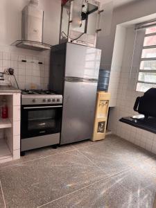 a kitchen with a refrigerator and a stove at Cómodo apartamento en el centro de caraca in Caracas