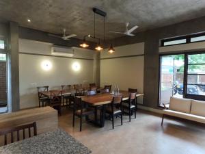 a dining room with a table and chairs at Savana Luxury Stay in Pondicherry