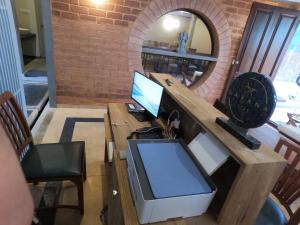 an office with a desk with a computer and a mirror at Savana Luxury Stay in Pondicherry