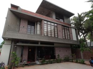 a large building with a balcony on top of it at Savana Luxury Stay in Pondicherry