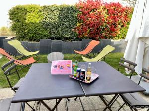 a black table with bottles and drinks on a patio at Greg House 49 - Chambres d'Hôtes in Beaupréau