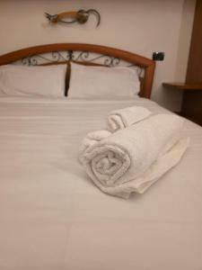a bed with two towels sitting on top of it at Rolly Home - Verona Apartment in Verona