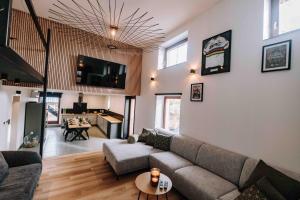 a living room with a couch and a table at Gîte Grise Pierre in Herve +18 photos