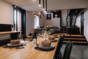a dining room with a long table with wine glasses at Gîte Grise Pierre in Herve