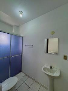a bathroom with a toilet and a sink at Oceano Hotel de Barra Velha in Barra Velha +18 photos
