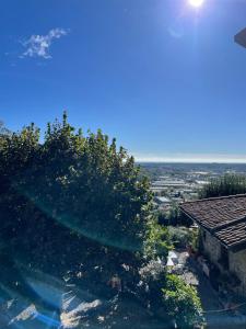 a view of a tree and a house with the sky at B&B Il Castellaccio - Albavilla in Albavilla