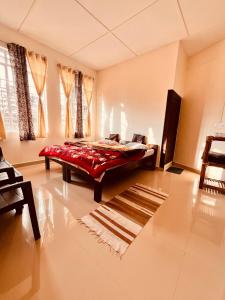 a bedroom with a bed in the middle of a room at Kusum Nest in Shillong