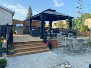 a deck with a gazebo and a table and chairs at Gull lake in Winnipeg