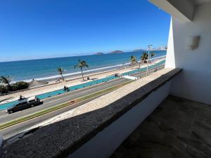 a view of the beach from the balcony of a building at Hotel De Cima Beach Club in Mazatlán