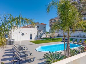a swimming pool with chaise lounge chairs and a resort at Villa Garden - 22 Guests - 2 Pools in Albufeira