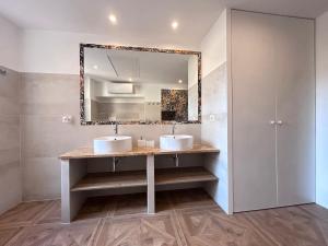 a bathroom with two sinks and a mirror at Vicolo Doria Apartment in Rome +24 photos