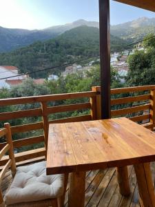a wooden table and chairs on a balcony with a view at La Posada de Botavara in Mijares