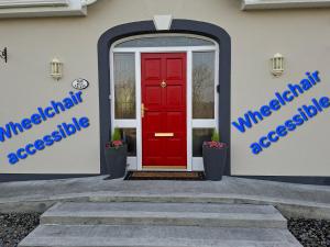a red door on the side of a house at Rockfield Manor B&B, Knock in Knock