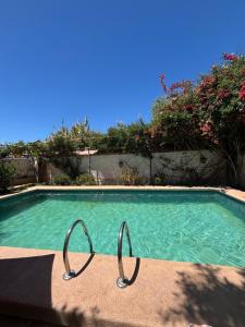 a swimming pool with two metal handles in it at Alojamiento La Rosa in Combarbalá +7 photos