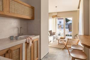 a kitchen and living room with a table at Cavo Dio 2 - Beachfront Bliss - Cozy Apt Pool Sunsets in Dhiminión