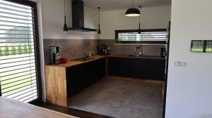 a kitchen with a sink and a counter top at Dom Mazury in Langendorf