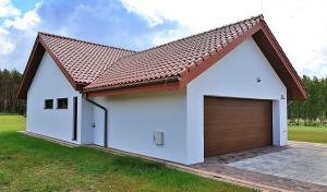 a white garage with a brown roof at Dom Mazury in Langendorf