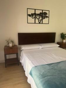 a bedroom with a bed and a table with a picture on the wall at CASAMONTl in Sanet y Negrals +25 photos