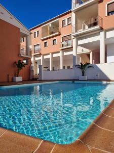 a swimming pool in front of a building at CASAMONTl in Sanet y Negrals