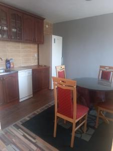 a kitchen with a table and chairs in it at Sonja Sea View House in Zagrađe