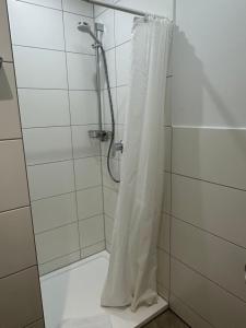 a shower with a shower curtain in a bathroom at Gestütsgasthof Marbach in Marbach +7 photos