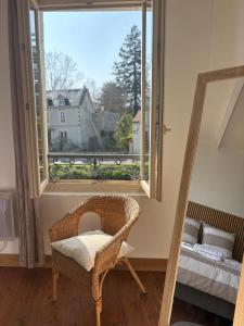 a room with a chair and a large window at Maison bord de sèvre in Coulon