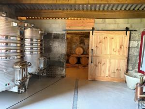 a bathroom with a wooden door and a sink at Château Clos des Maurins in Vérac +20 photos