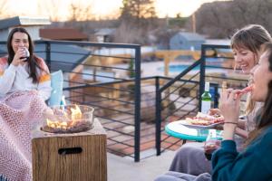 a group of people sitting around a table on a patio at Timber & Tin D 2Bed 2Bath w Pool & Rooftop Deck in Kanab +105 photos