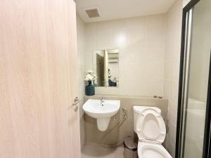 a bathroom with a toilet and a sink at Dcondo reef artificial pavement Prime location in Kathu +11 photos