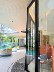 a glass door leading to a pool in a building at Dcondo reef artificial pavement Prime location in Kathu