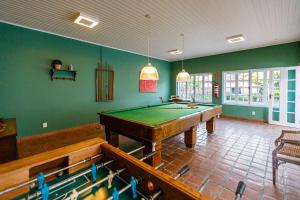 a pool table in a room with green walls at Fazenda Santanna Hotel in Amparo