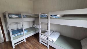 a room with three bunk beds in a room at Vintage Resort in Sarud