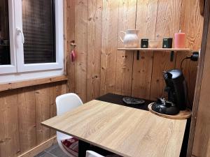 a kitchen with a table with a coffee maker on it at Logicoeur in Gérardmer +13 photos