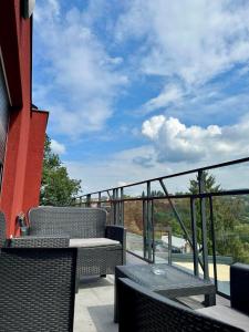 a patio with two chairs and a table on a balcony at VIP House 5 in Vrnjačka Banja